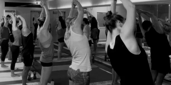 Student practicing Vinyasa Flow at yogafusion yoga Adelaide studio – explore hot, warm and yin yoga styles to build strength and calm the mind