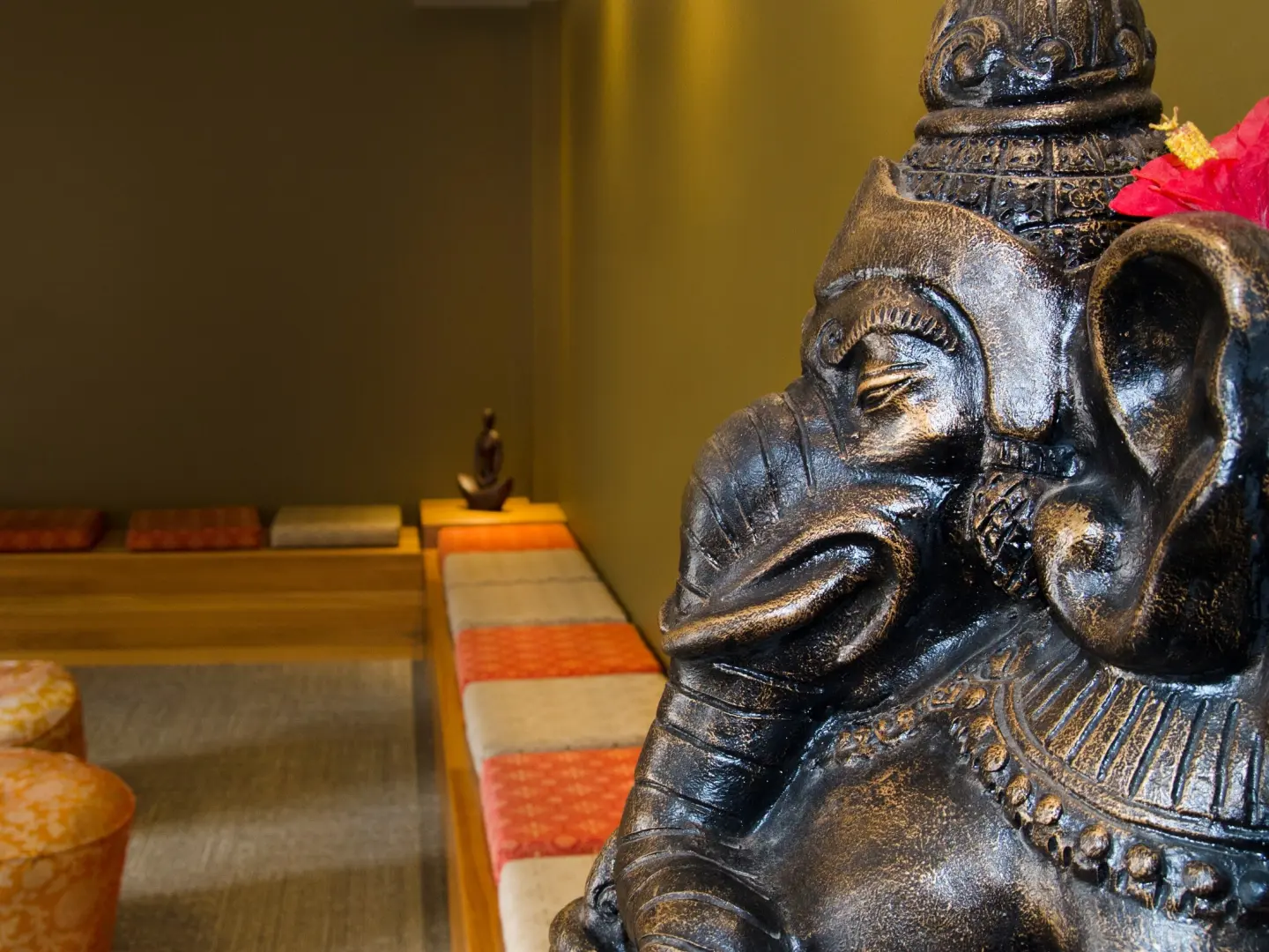 Ganesha statue, seats and benches in yogafusion's main foyer