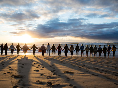 yogafusion yoga retreat group standing on the beach